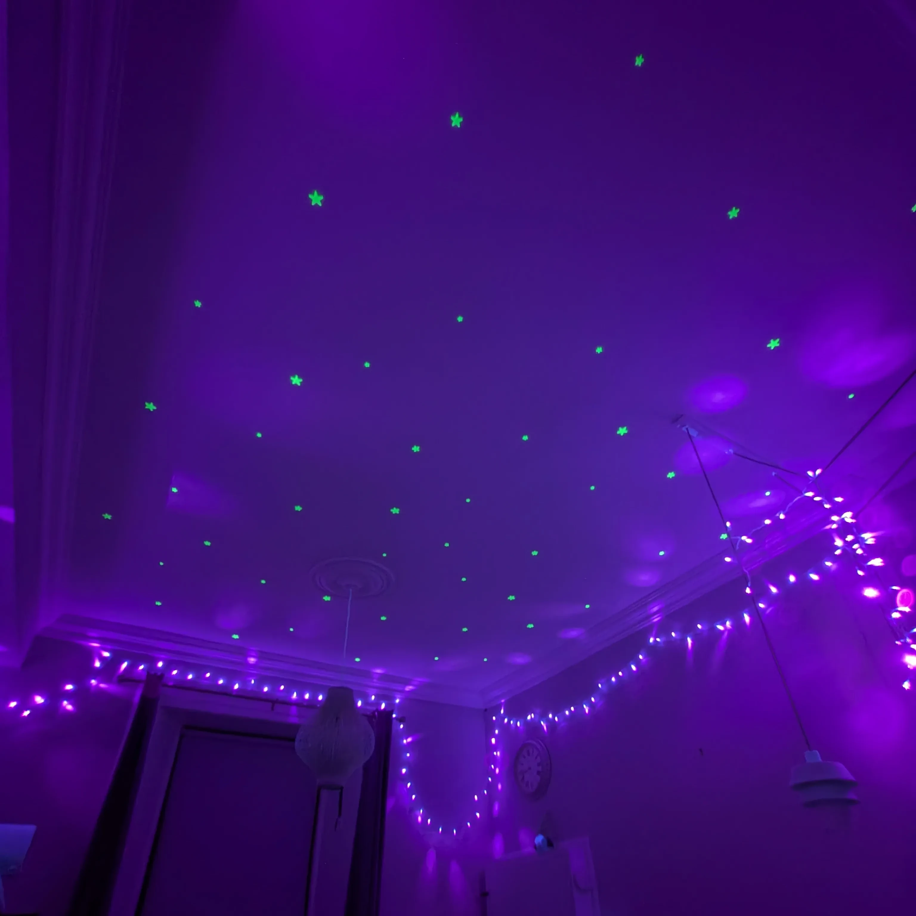 UV-reactive stars on the ceiling, lit up by UV fairy lights